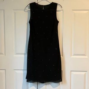 Your new LBD! Understated elegant black dress with small jewel accents.